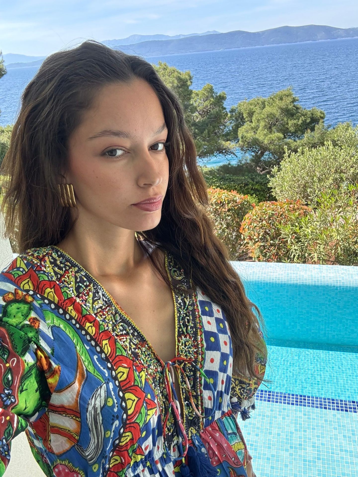 Dorothea by the pool overlooking the Adriatic